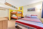 Bedroom with queen bed and twin bunkbeds